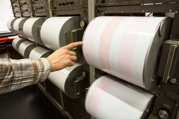 istock Seismograph recording earthquake human hand 647845466