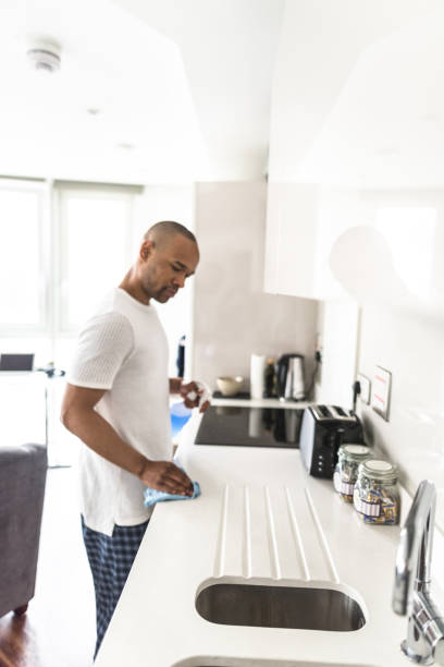 istock man cleaning the house 647848104