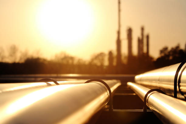 golden steel pipe network in crude oil refinery stock photo