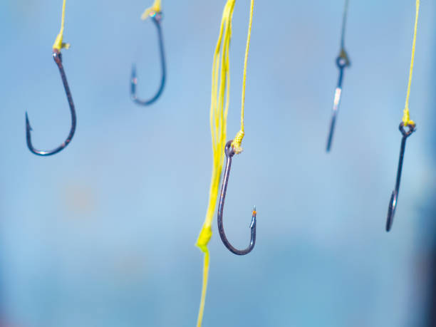 istock fishing hooks on a yellow fishing line 647855610