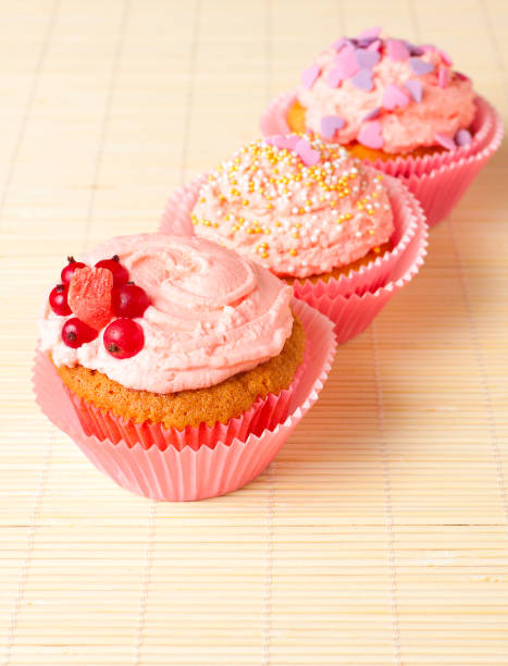 istock sweet cupcakes with cream and berries 647855774