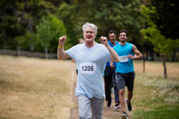 istock Athletes running race in park 647863994