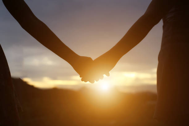 istock young couple holding hands. In Nature sunrise 647865806
