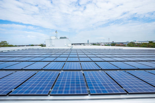 istock Solar panels on factory roof 647878352