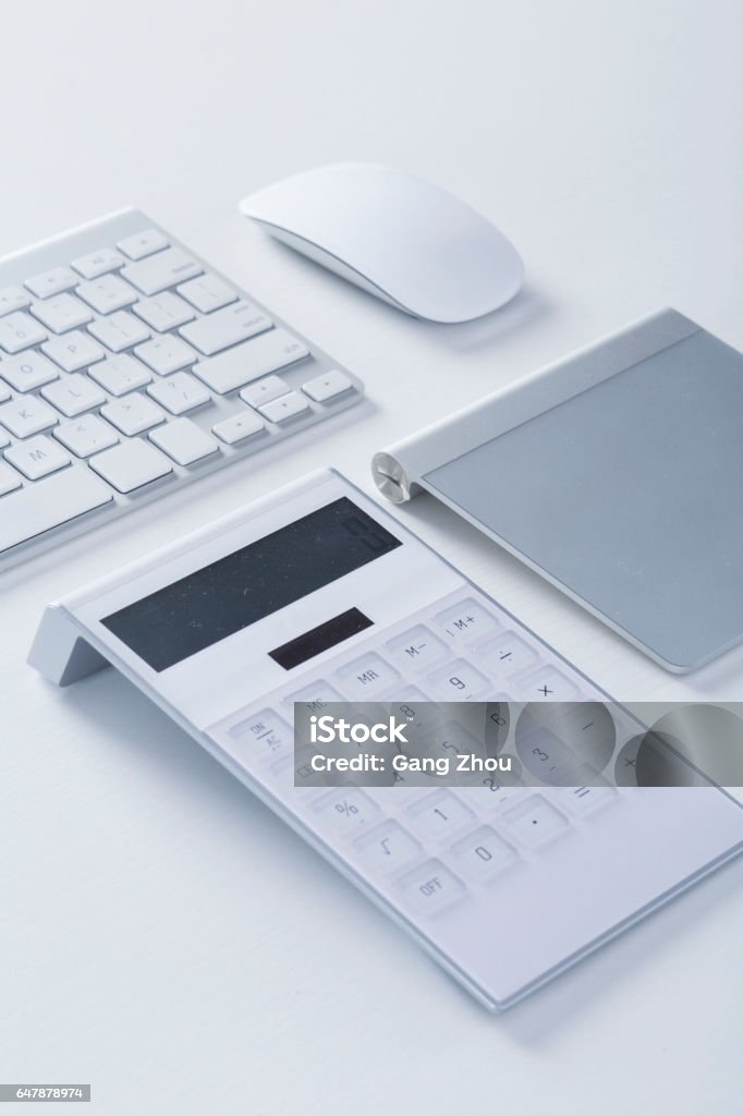 Modern White office desk table with keyboard, mouse, calculator,and wacom Modern White office desk table with keyboard, mouse, calculator,and wacom.Top view. Calculator Stock Photo