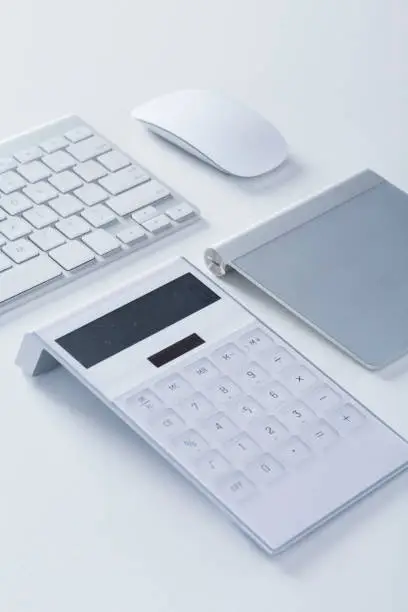 Modern White office desk table with keyboard, mouse, calculator,and wacom.Top view.