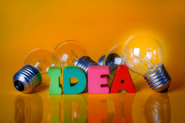 istock Clear Light Bulb with Colorful Wooden Alphabets 647882266