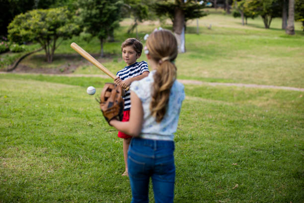 istock Boy and girl playing baseball 647957600