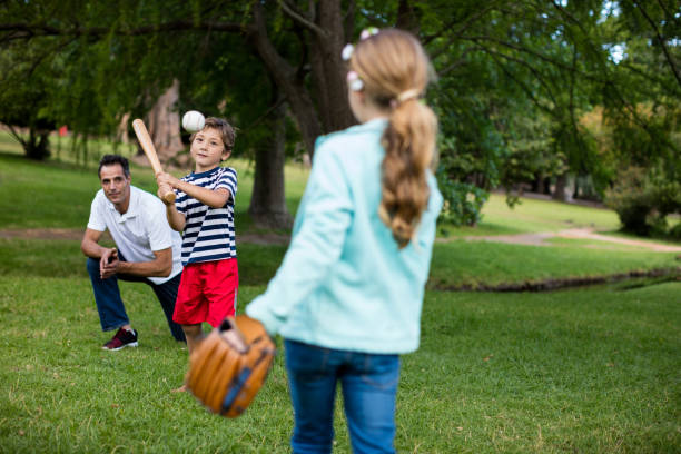 istock Family playing baseball in the park 647957816