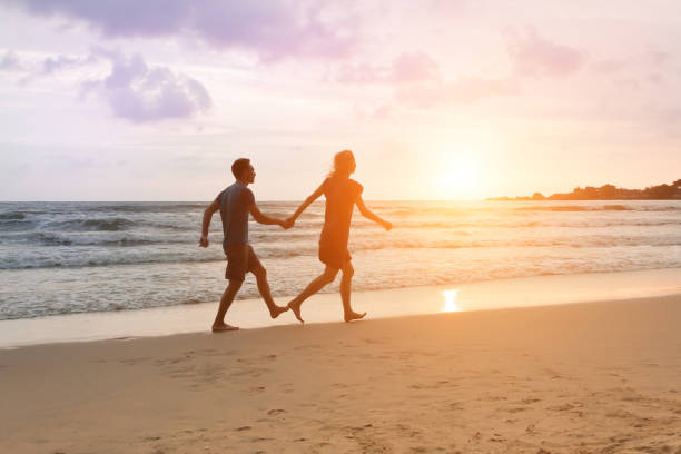 istock Romantic couple running and holding hands 647959524