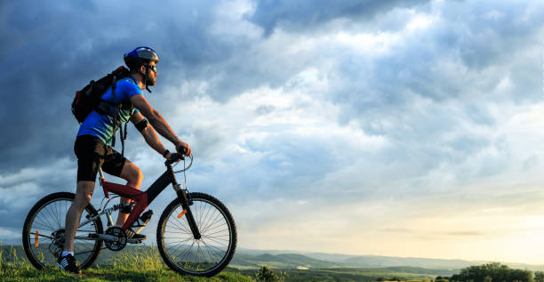 istock Mountain biker standing on top and looking at view 647967832