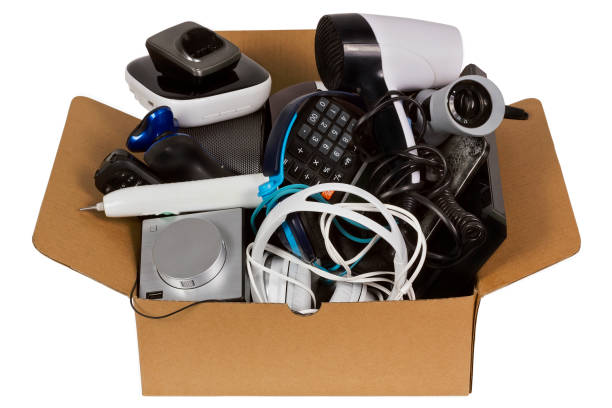 istock Green electronics concept. Household video audio and health broken electronic devices  in cardboard industrial box are prepared for utilization. Isolated with patch 647968218