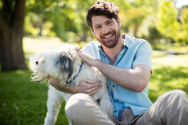 istock Man with dog in park 647971010
