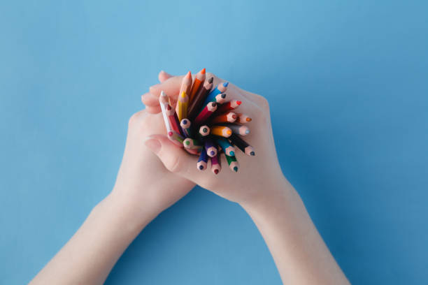 istock Hands full of bunch colored pencils 647974474