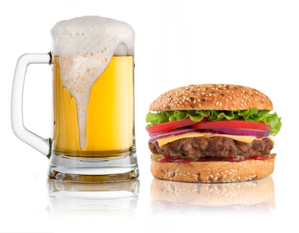 istock Hamburger and glass of beer isolated on white 647975316