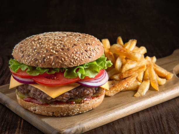 istock fresh tasty burger and potatoes on wooden board 647975324