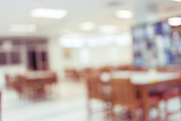 istock library with table desk and bookshelf, abstract blur defocused background 647975330