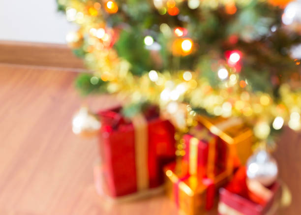 istock blur light celebration on christmas tree with gift box in living room 647978410