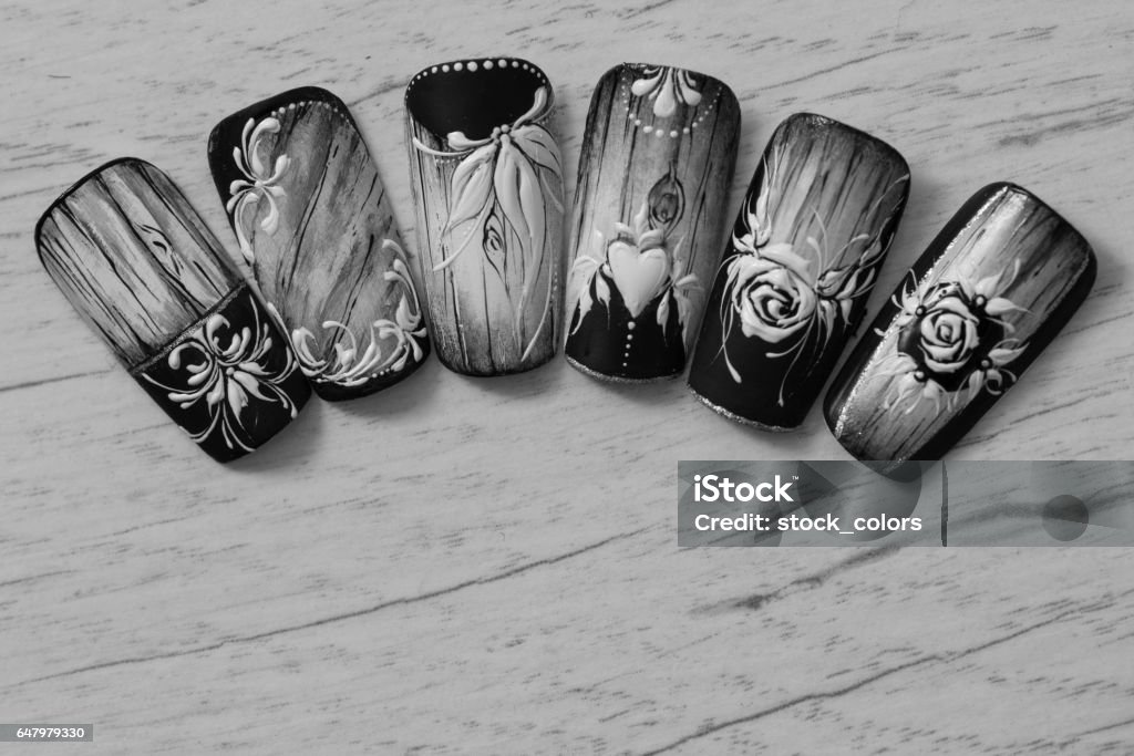 floral pattern nails monochrome shot of floral pattern artificial nails on table inside nails salon. Artificial Stock Photo