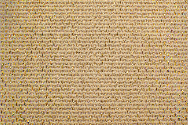 beige natural linen fabric with brilliance golden lurex close-up. aida texture for the background - embroidery cross stitch textured linen imagens e fotografias de stock