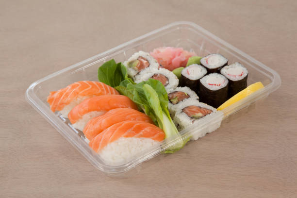 istock Set of assorted sushi kept in a plastic box 647985756
