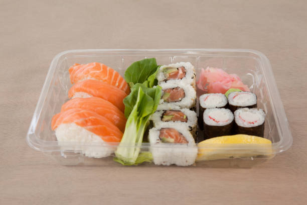 istock Set of assorted sushi kept in a plastic box 647985862