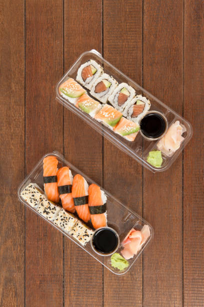 istock Set of assorted sushi served in a plastic boxes 647986774