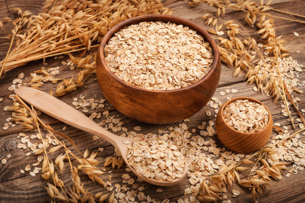 istock oat flakes on the old board. food concept 647989500