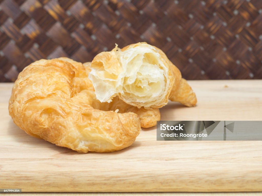 Split Croissant on cutting board close up Baked Stock Photo