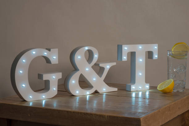 istock Dimly Illuminated Decorative Letters spelling Gin and Tonic G&T 647998148