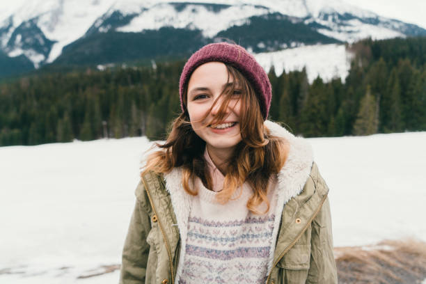 Young Caucasian woman resting in the mountains in winter