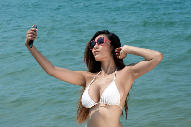 istock Pretty Asian woman taking a selfie. 648001812