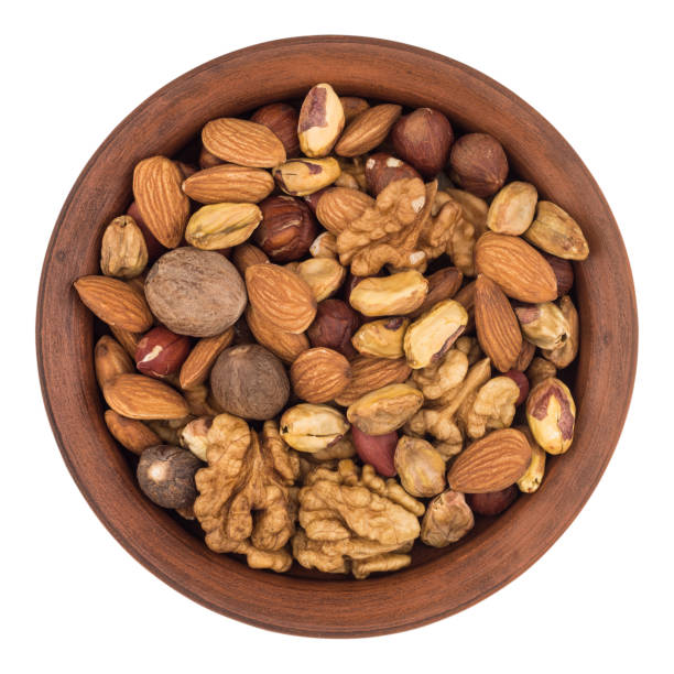 istock Mixture of nuts in a ceramic bowl isolated on white background. 648005554