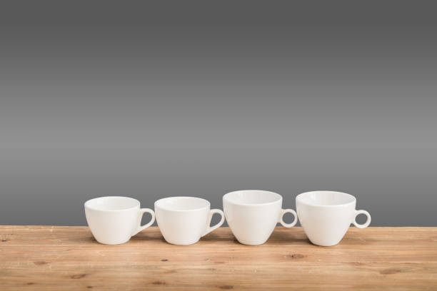 istock White coffee cups on the wooden table 648011408