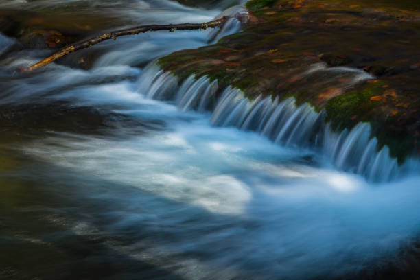 istock Pristine waterfalls deep in the woods, on a bright sunny day in spring 648012578