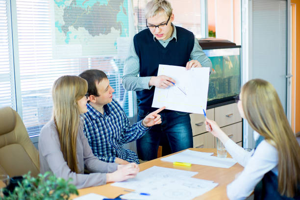 istock discussion of workers at the desk business ideas 648012732