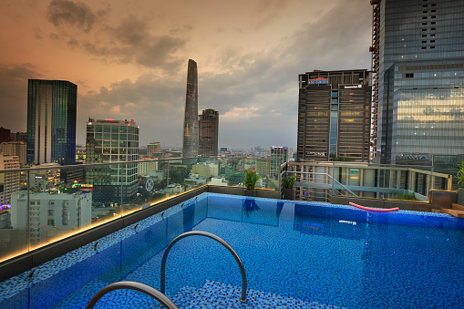 Ho Chi Minh city, Vietnam - February 27, 2017: a swimming pool on the terrace of a building in the city of Ho Chi Minh City at dusk. Ho Chi Minh City is the commercial center and cultural of VN
