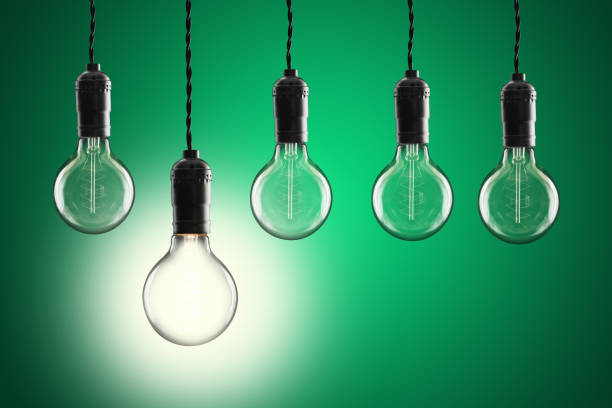 istock Idea and leadership concept Vintage incandescent Edison bulbs on color background 648038392