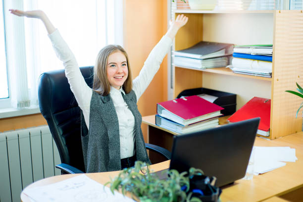 istock worker sitting in front of laptop 648042716