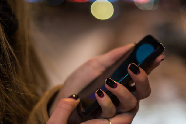 istock Woman using smartphone at night close up 648046688