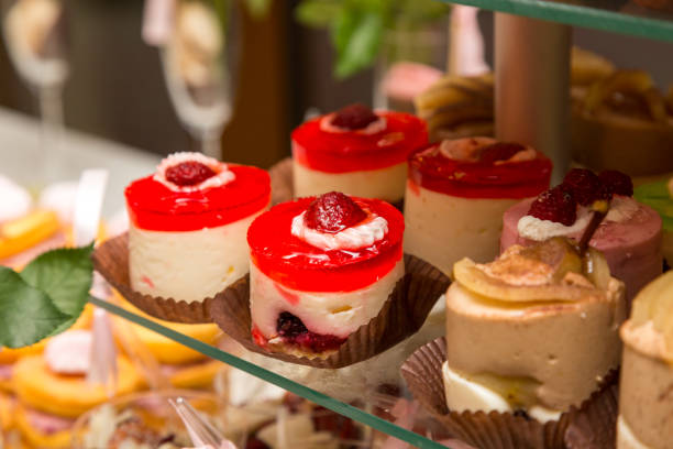 istock Dessert table for a party. Ombre cake, cupcakes. Candy bar 648059166