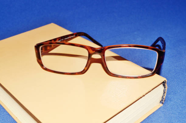 istock Glasses on the background of the book. 648062288