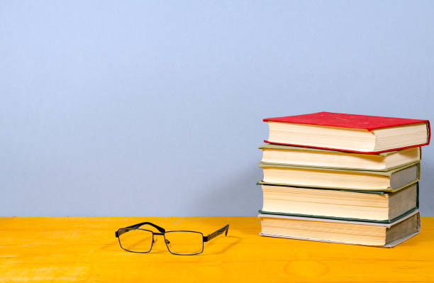 istock several books and glasses on a wooden surface 648066324