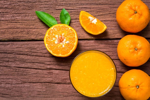 istock Orange juice on a wooden table 648078154