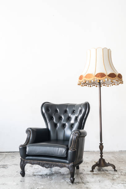 istock vintage armchair and lamp on white wall. 648080916