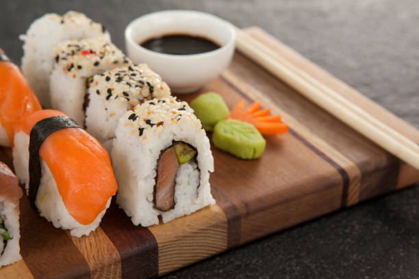 istock Assorted sushi set served with chopsticks and soy sauce on wooden board 648081060