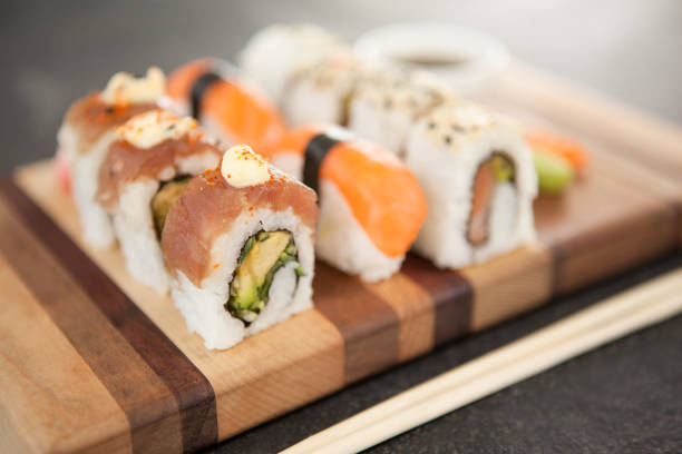 istock Assorted sushi set served on wooden board 648081370