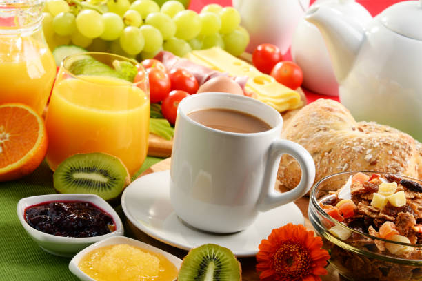 istock Breakfast served with coffee, orange juice, egg and fruits 648084008