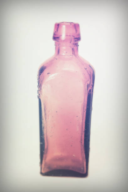 istock Old colourful bottles against a white background 648084218