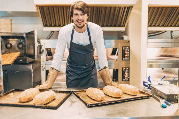 istock Baker with fresh loaves of bread 648084698